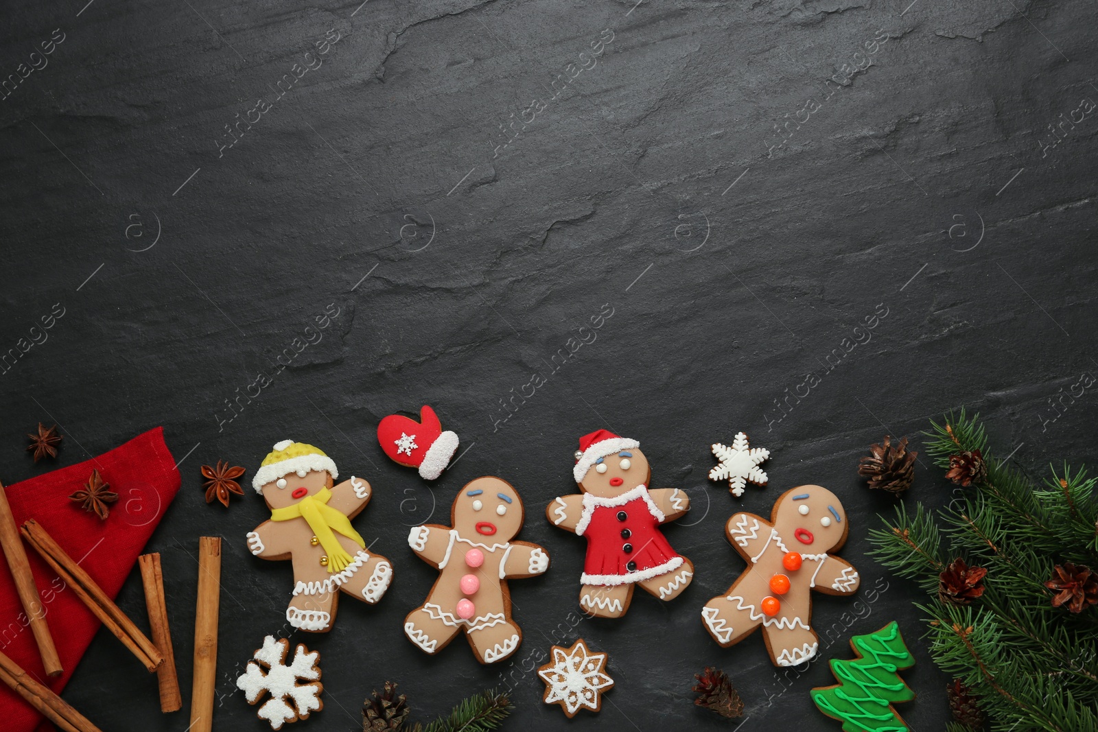 Photo of Flat lay composition with delicious Christmas cookies on black table, space for text