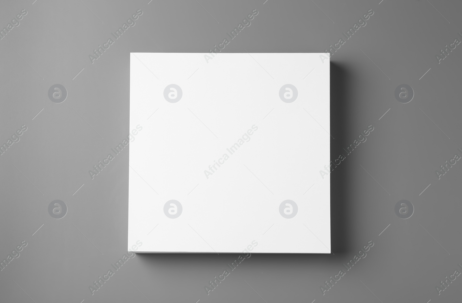 Photo of Stack of blank paper sheets for brochure on grey background, top view. Mock up