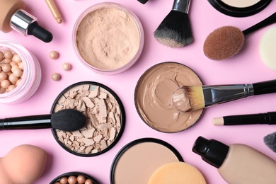 Flat lay composition with skin foundation, powder and beauty accessories on color background