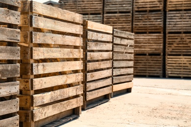 Photo of Old empty wooden crates outdoors on sunny day. Space for text