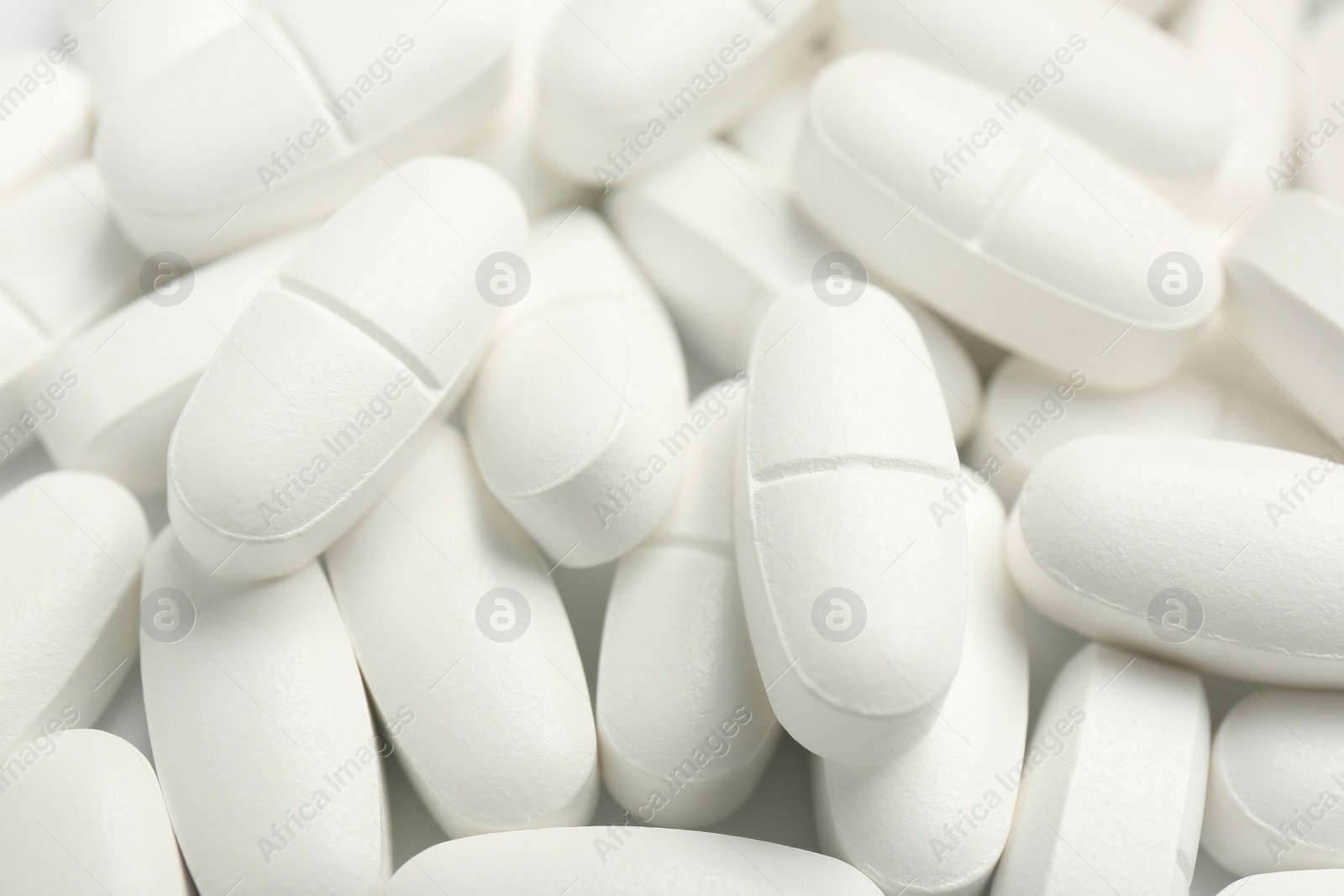 Photo of Many white vitamin capsules as background, closeup