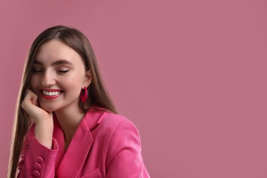 Photo of Beautiful woman in pink clothes on color background, space for text