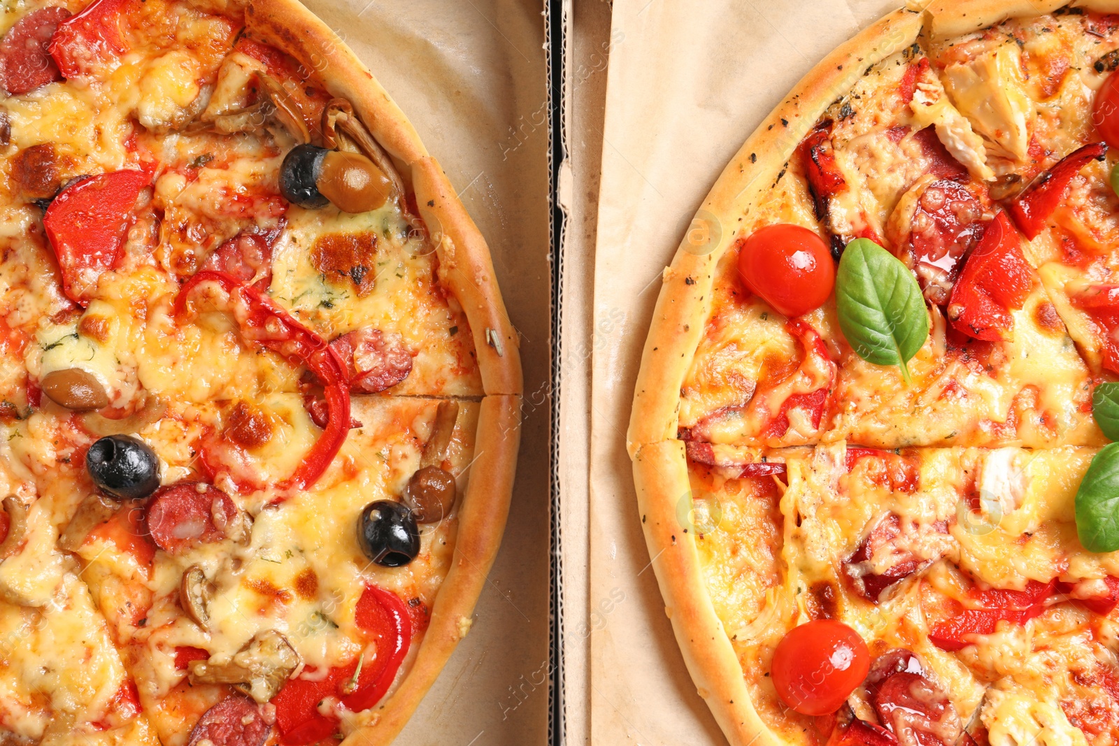 Photo of Cardboard boxes with delicious pizzas, top view