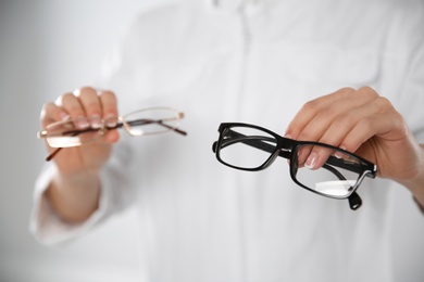 Photo of Female ophthalmologist with eyeglasses in clinic, closeup