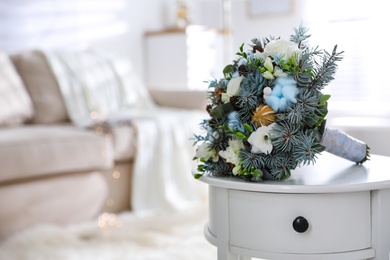 Photo of Beautiful wedding winter bouquet on white table indoors. Space for text
