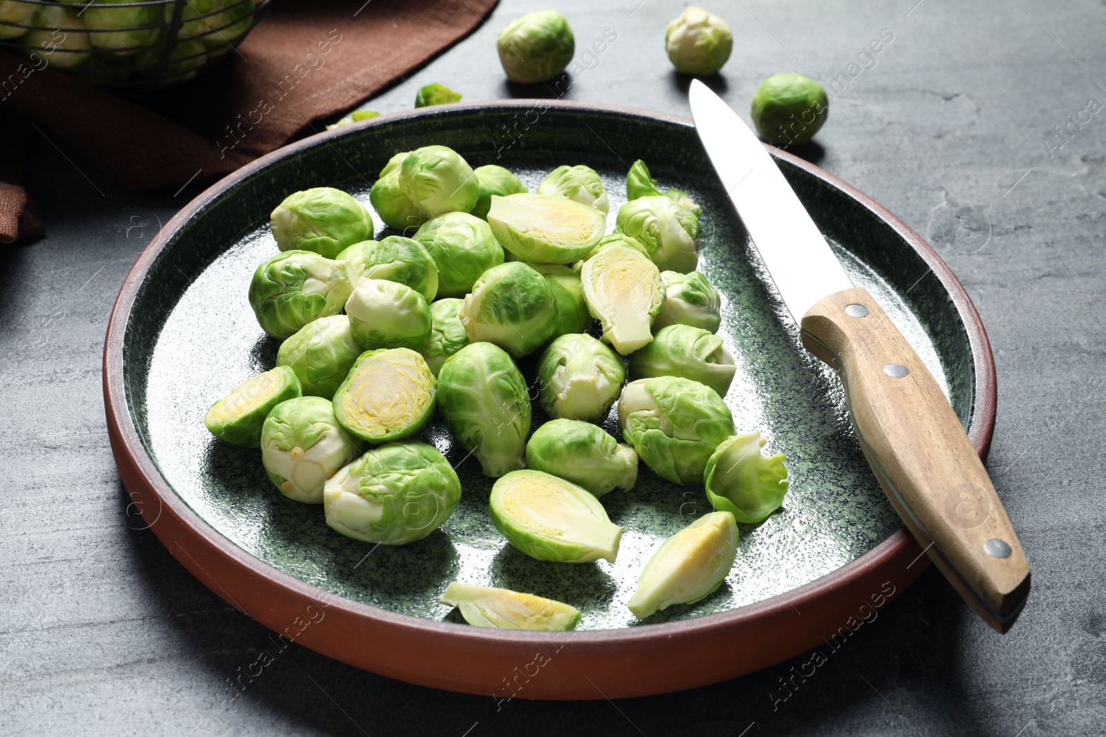 Photo of Plate with fresh Brussels sprouts on table