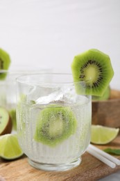 Photo of Glass of refreshing drink with kiwi on table