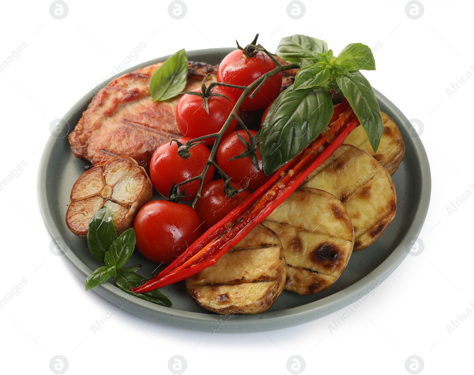 Photo of Plate with tasty grilled vegetables, meat and basil isolated on white