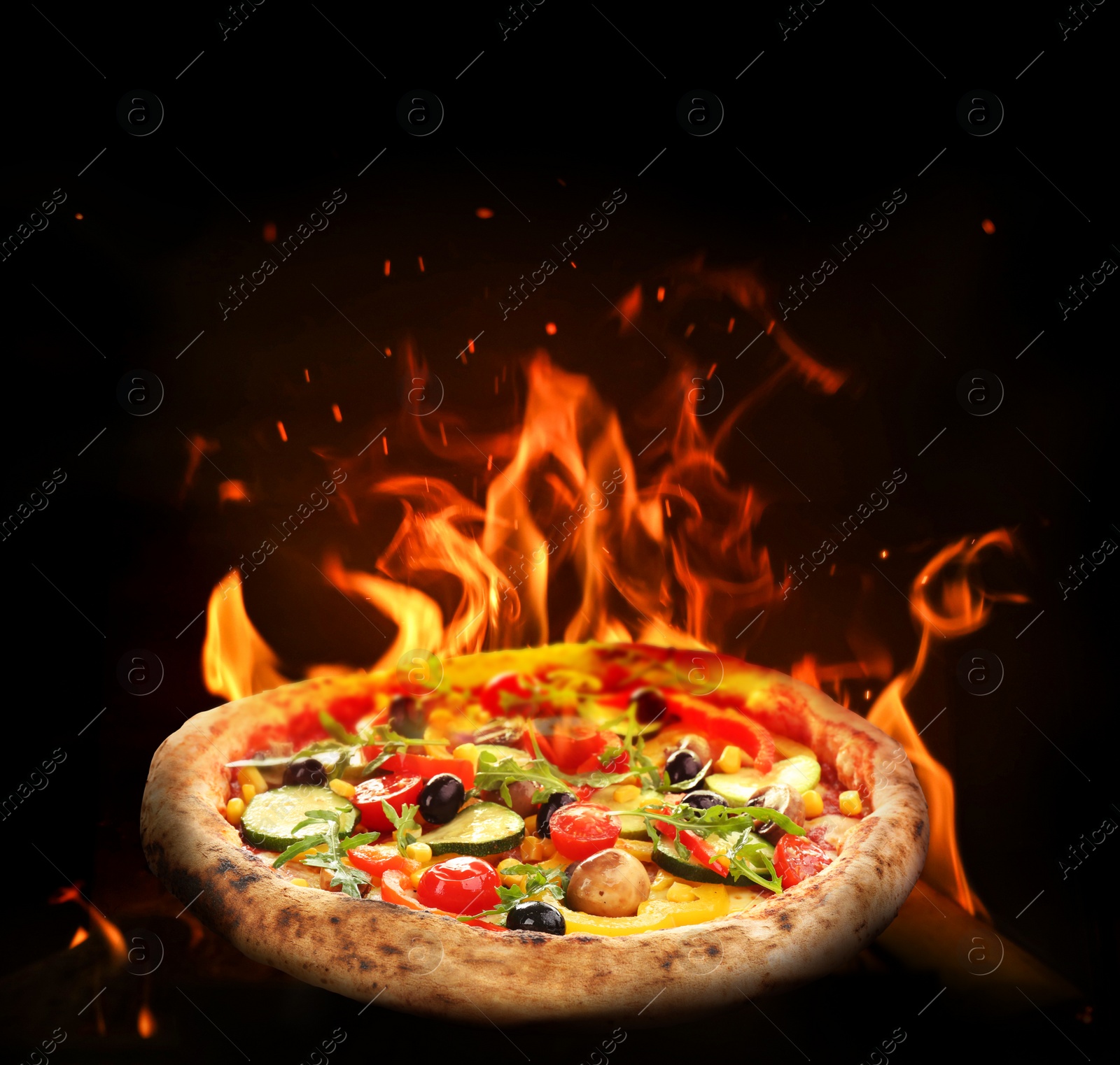 Image of Hot tasty pizza with fire flames on dark background. Image for menu or poster
