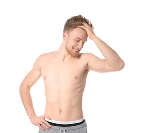 Portrait of young man with slim body on white background