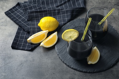 Photo of Glasses with natural black lemonade on table