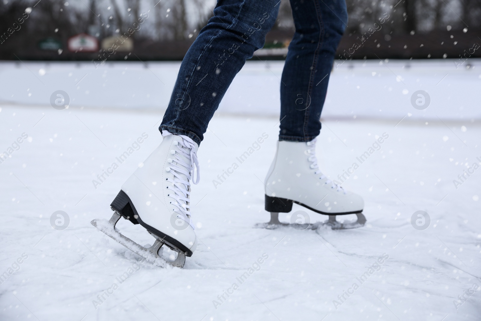 Image of Woman skating along ice rink outdoors, closeup