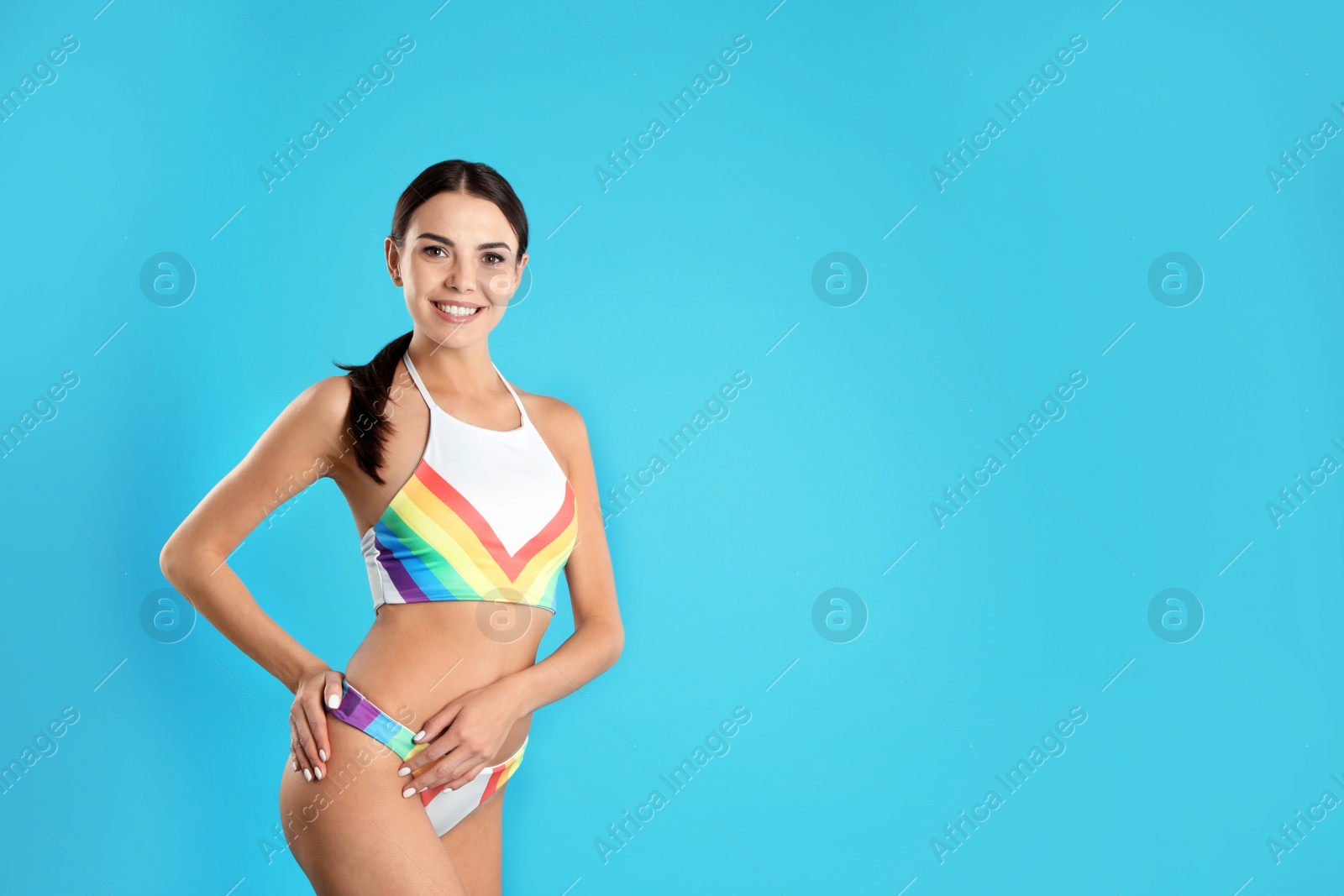 Photo of Portrait of attractive young woman with slim body in swimwear on color background. Space for text