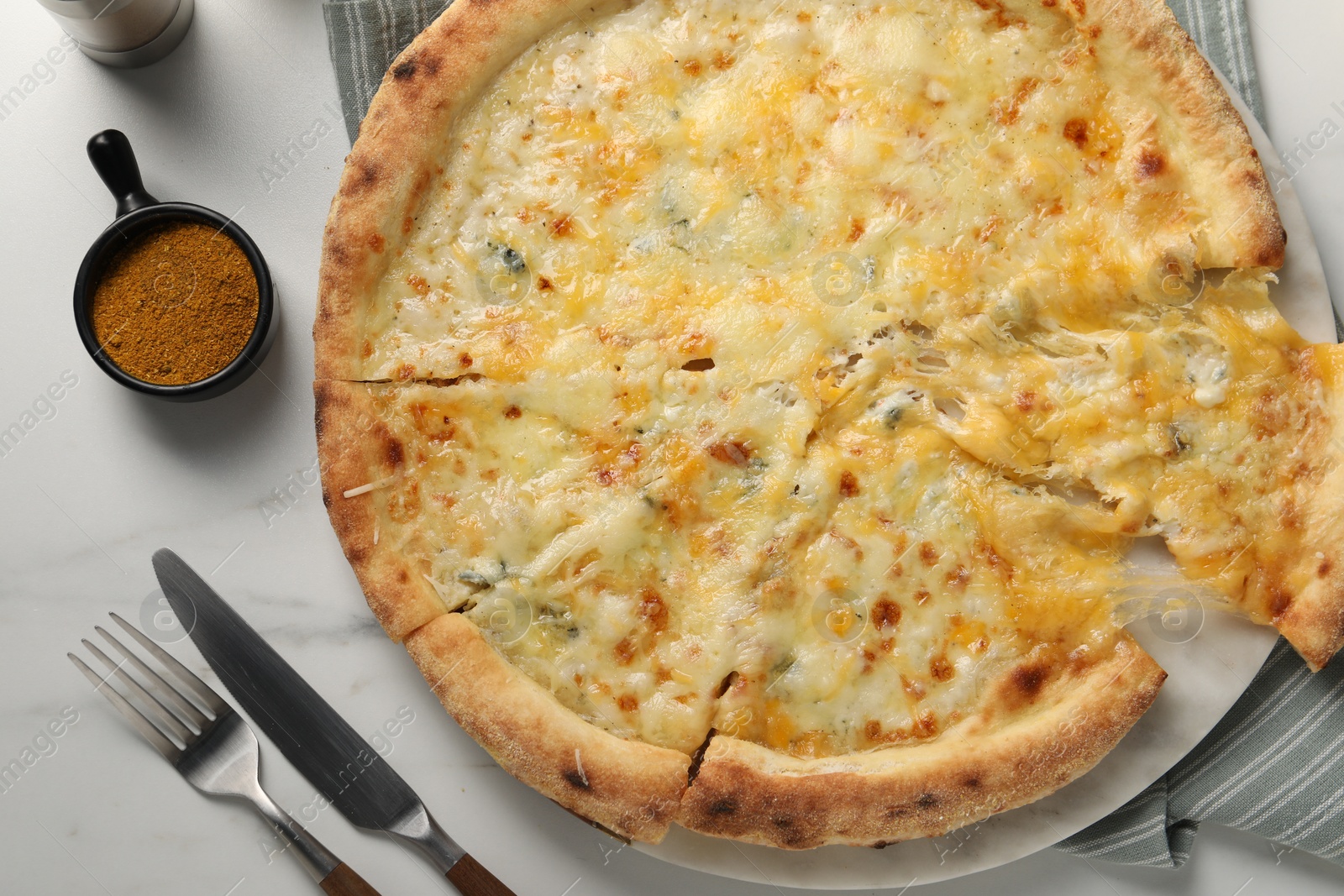 Photo of Delicious cheese pizza served on white marble table, flat lay