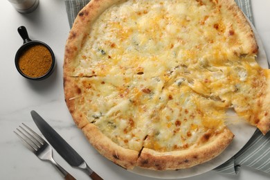 Delicious cheese pizza served on white marble table, flat lay