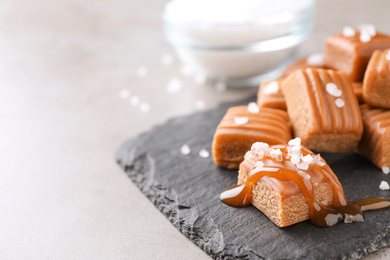 Photo of Salted caramel on light grey table, closeup. Space for text