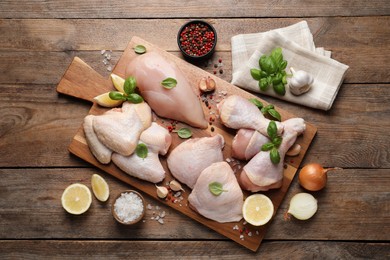 Photo of Flat lay composition with fresh raw chicken meat on wooden table