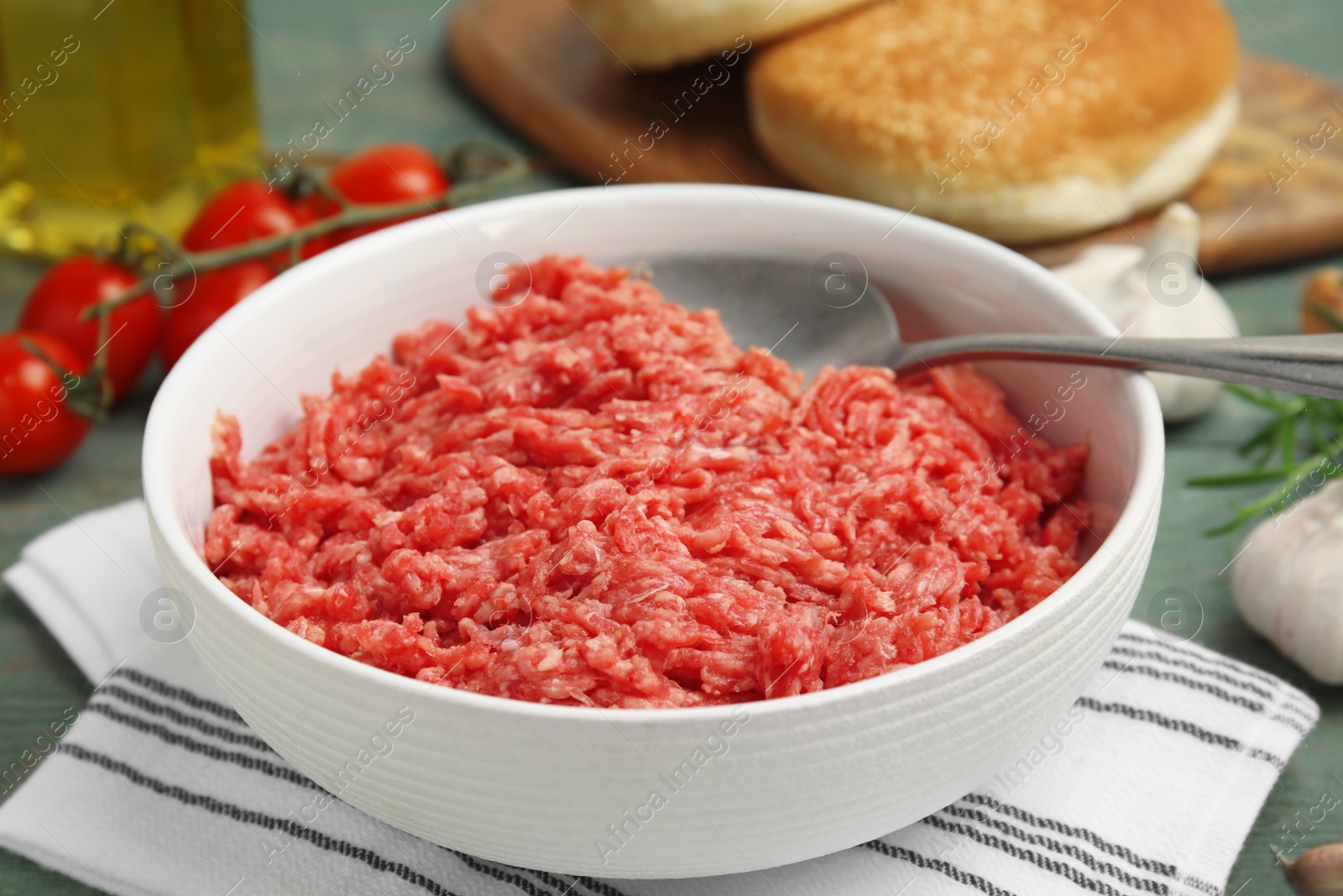 Photo of Fresh minced meat in bowl on table, closeup