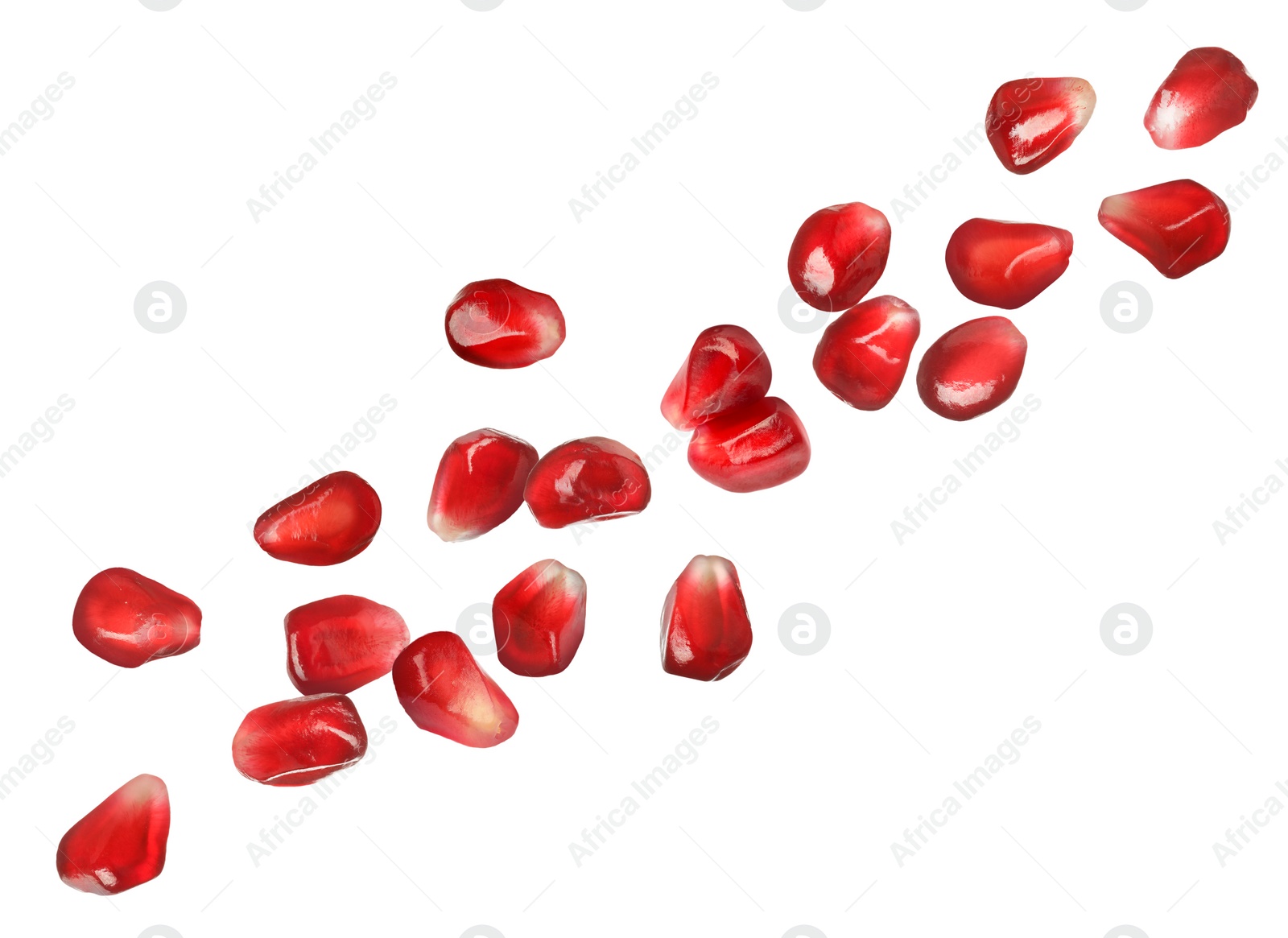 Image of Ripe juicy pomegranate seeds falling on white background