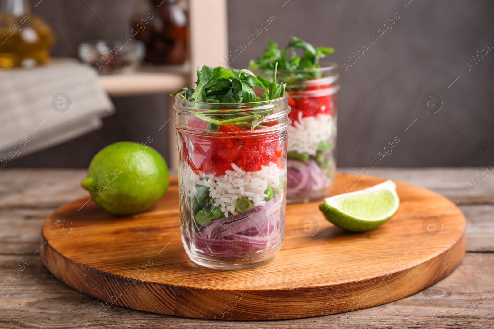 Photo of Healthy salad in glass jars on wooden table