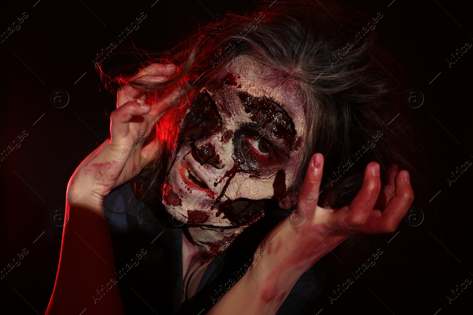 Photo of Scary zombie on dark background. Halloween monster