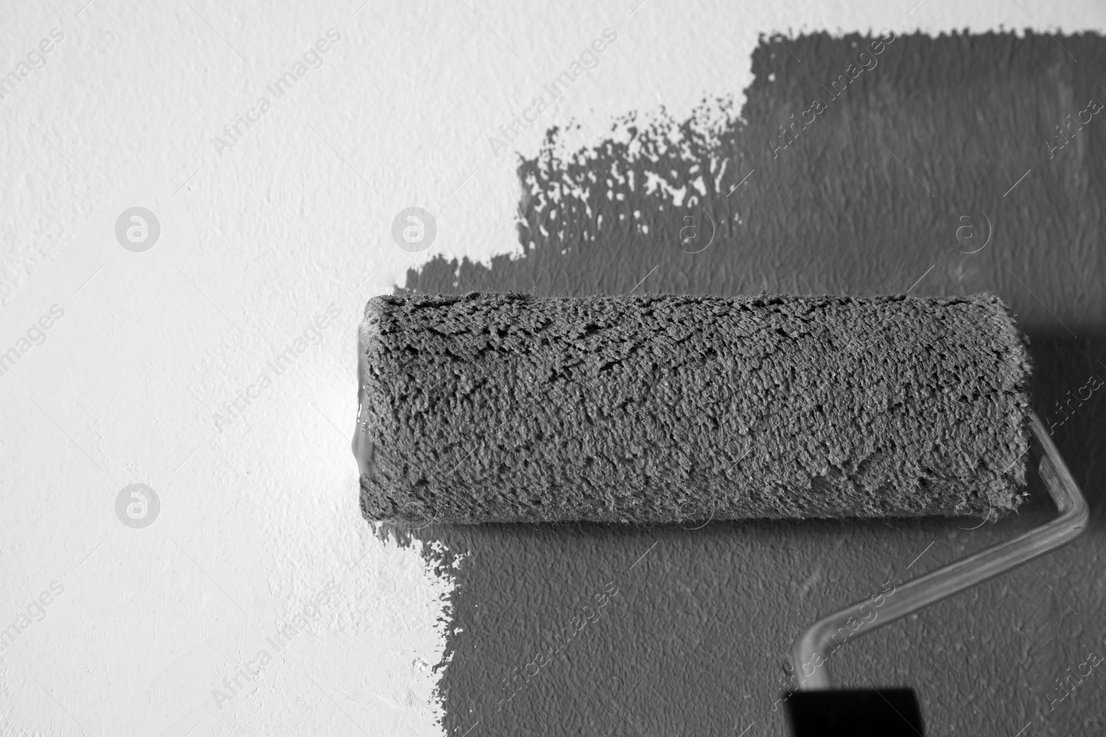 Photo of Painting white wall with grey dye, closeup view