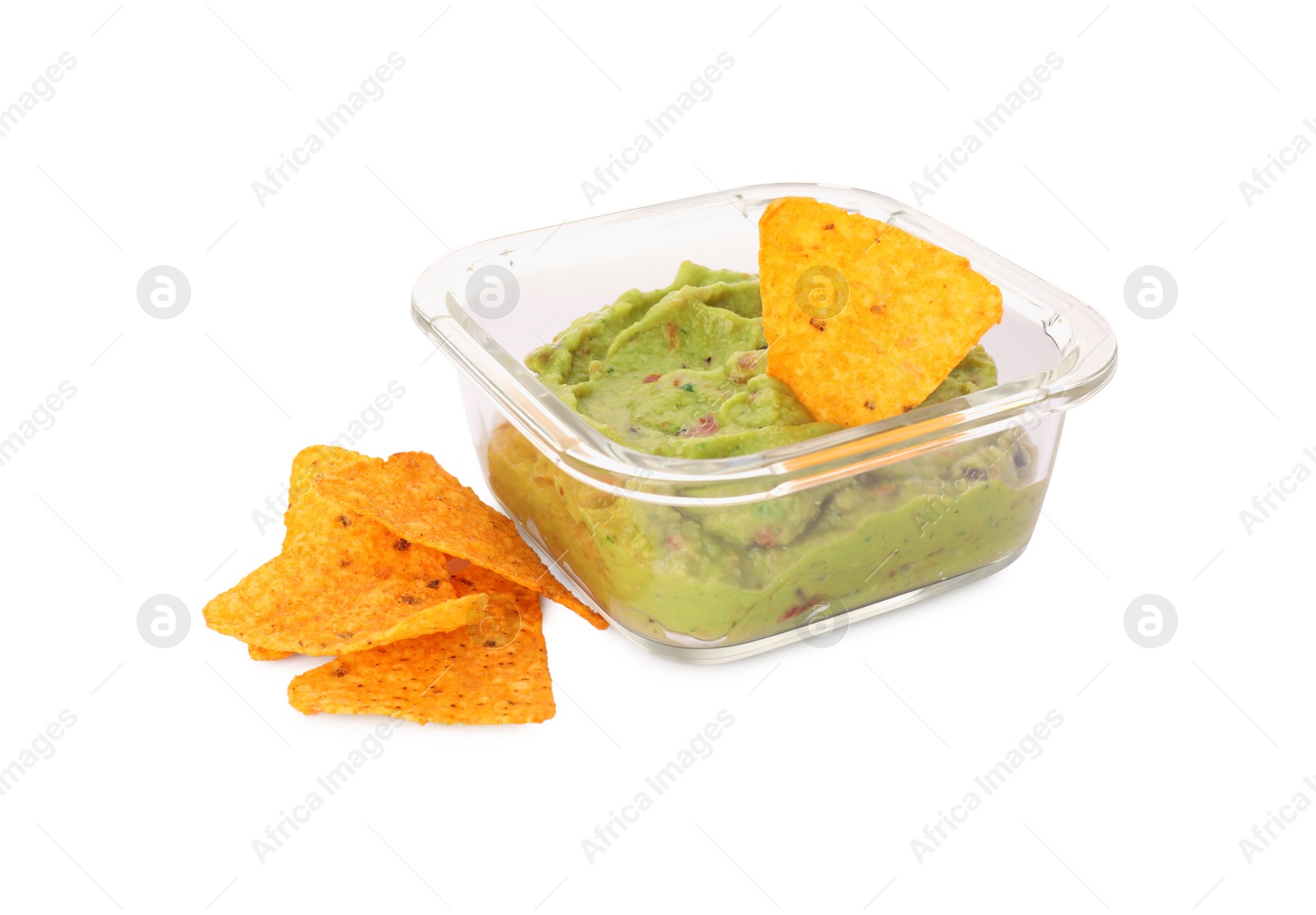 Photo of Bowl of delicious guacamole with nachos chips isolated on white