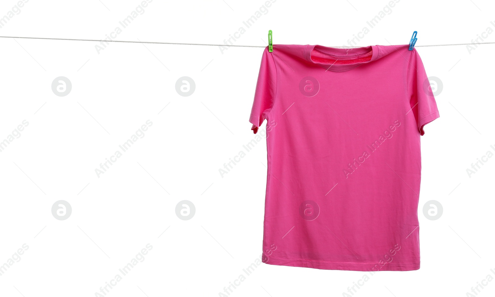 Photo of Pink t-shirt drying on washing line against white background