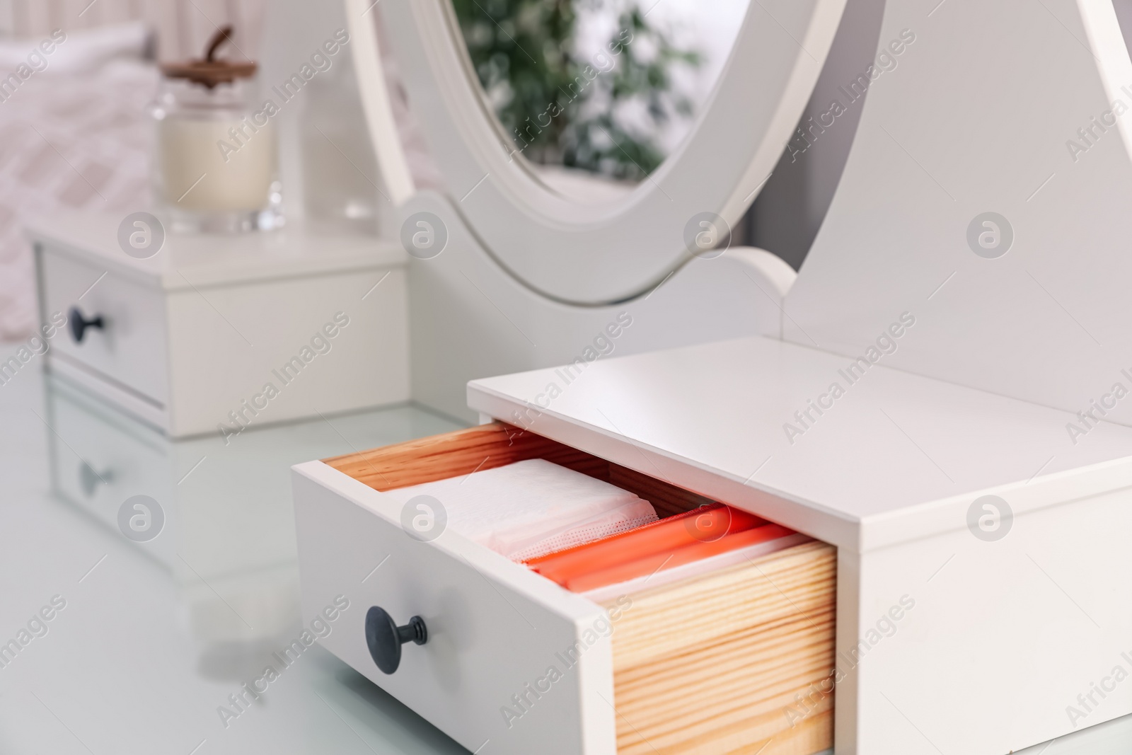 Photo of Different feminine hygiene products in drawer of dressing table indoors