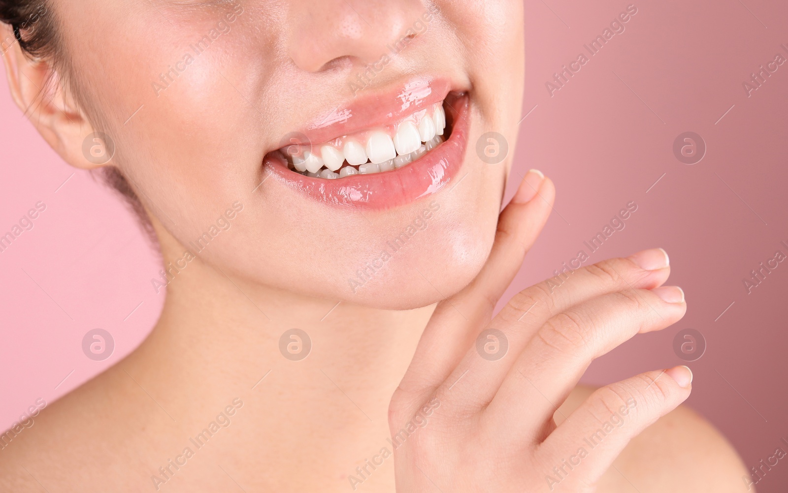 Photo of Beautiful young woman with healthy teeth on color background, closeup