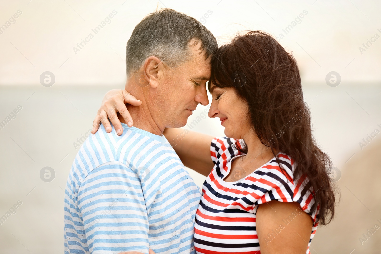 Photo of Happy mature couple spending time together on sea beach