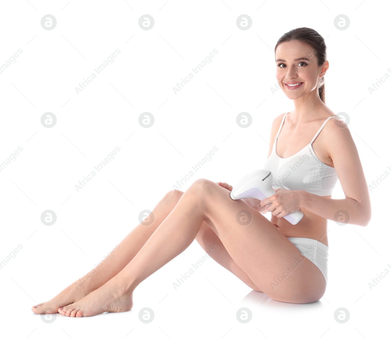 Photo of Young woman doing leg epilation procedure on white background
