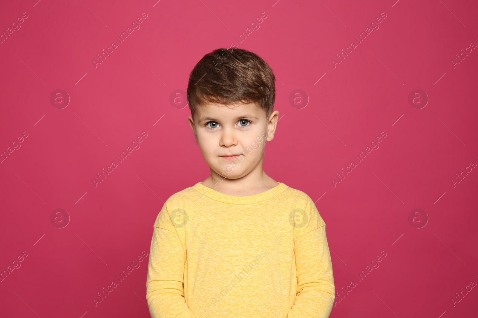 Photo of Portrait of cute little boy on color background