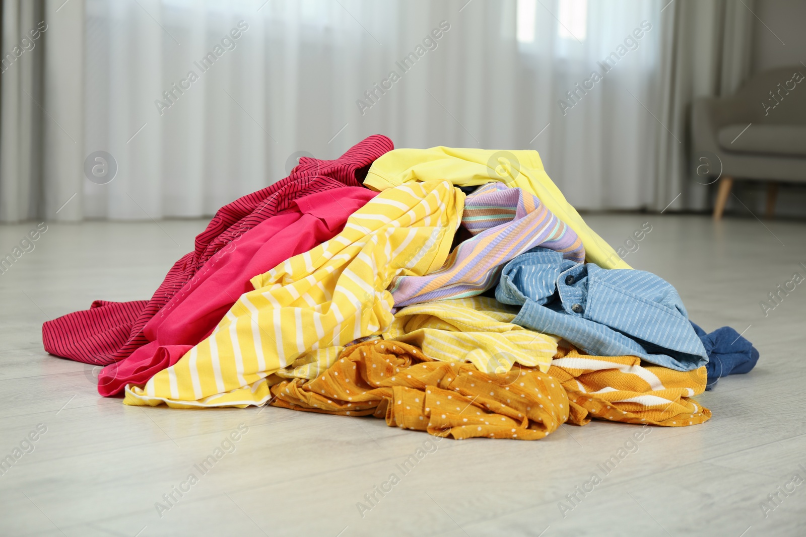 Photo of Pile of dirty clothes on floor indoors