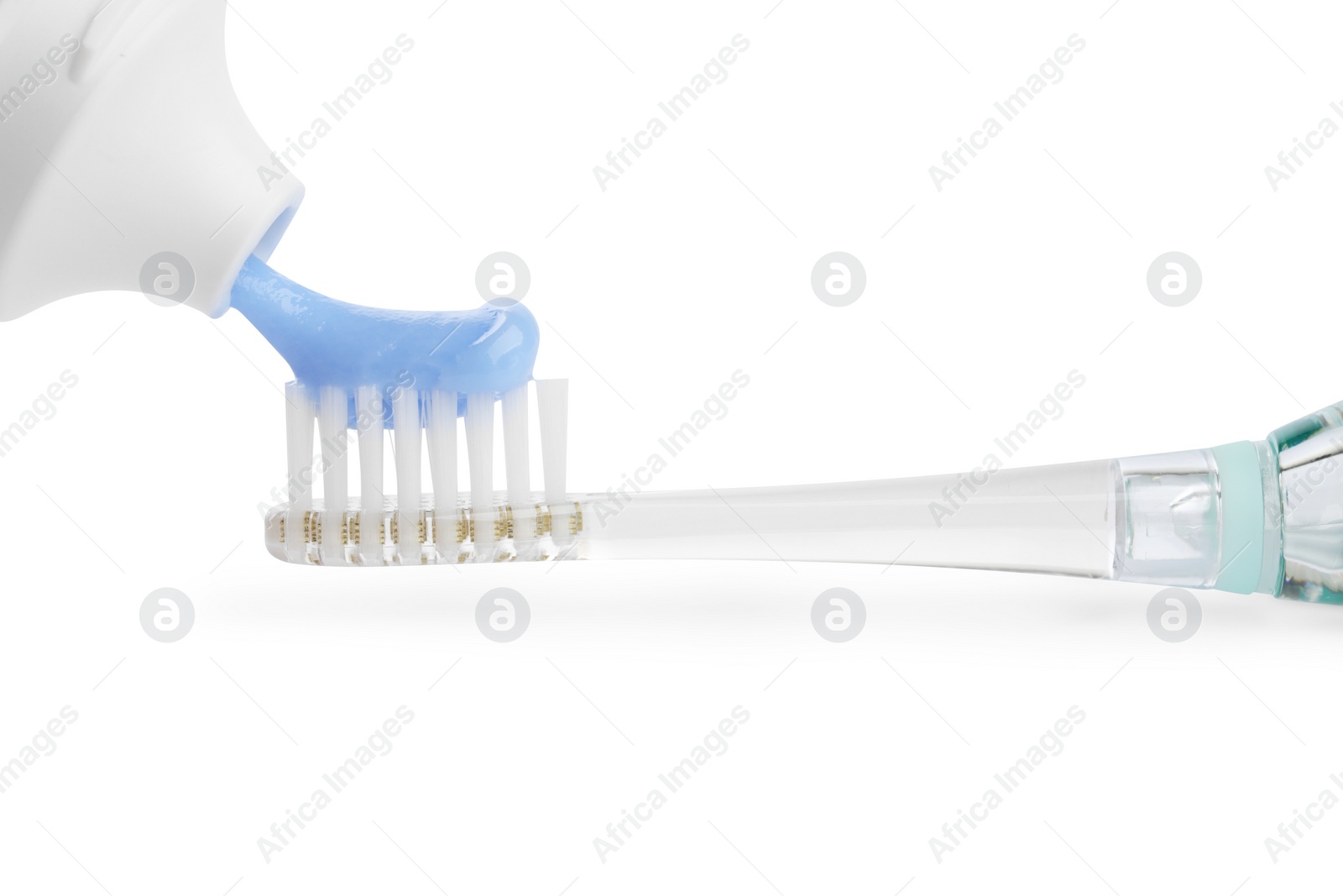 Photo of Squeezing toothpaste onto electric toothbrush isolated on white, closeup