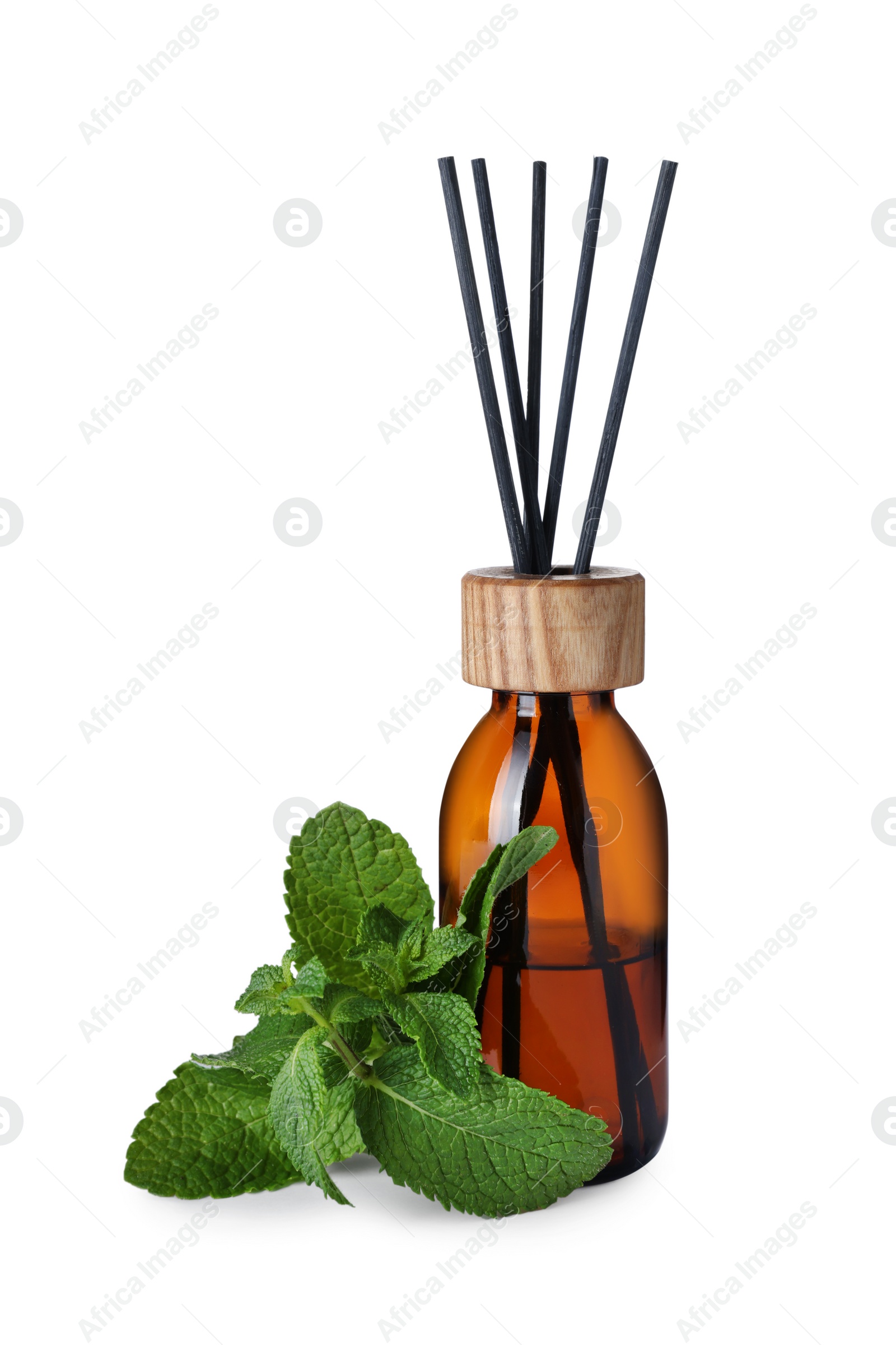 Photo of Aromatic reed air freshener and mint on white background