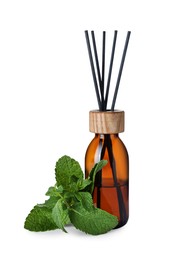 Aromatic reed air freshener and mint on white background