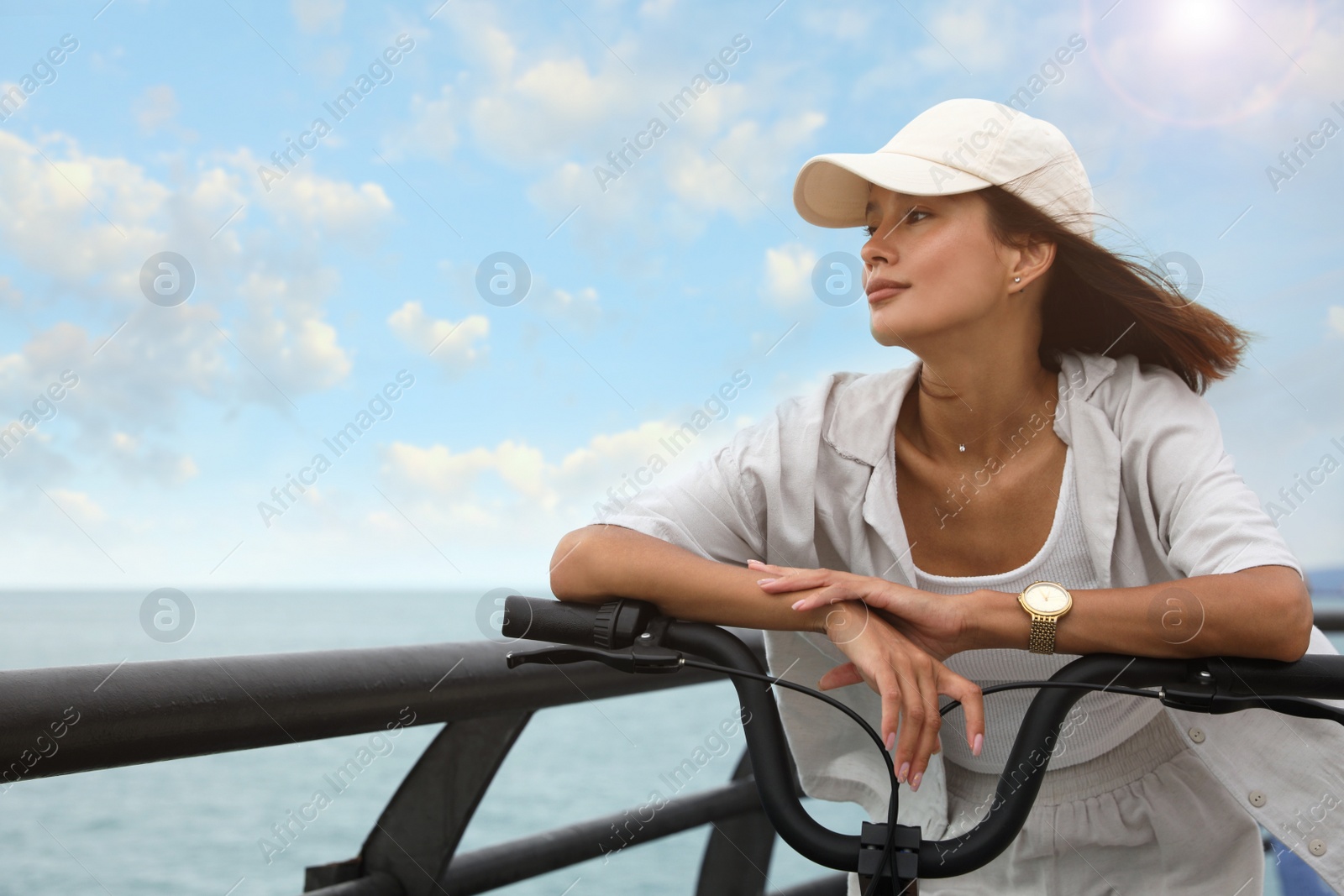 Photo of Beautiful young woman with bicycle near sea. Space for text