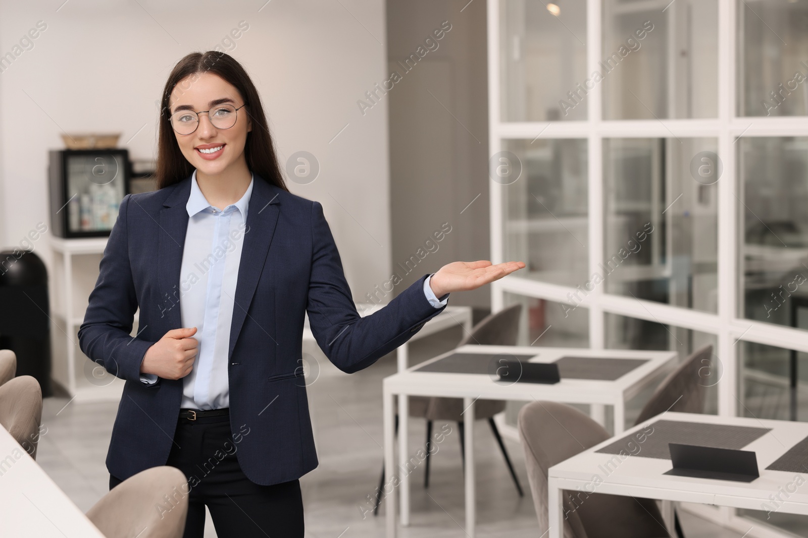 Photo of Happy real estate agent indoors. Space for text