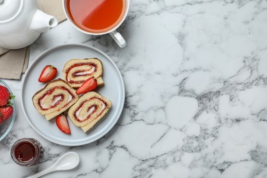 Tasty cake roll with strawberry jam and cream on white marble table, flat lay. Space for text