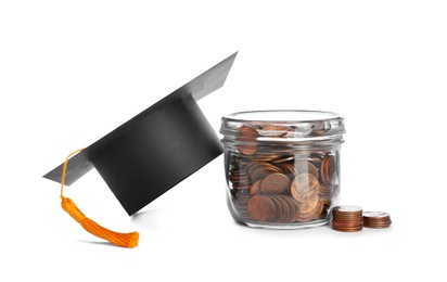 Photo of Graduation hat and jar with coins on white background. Money saving concept