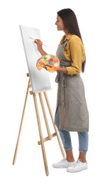 Young woman drawing on easel against white background