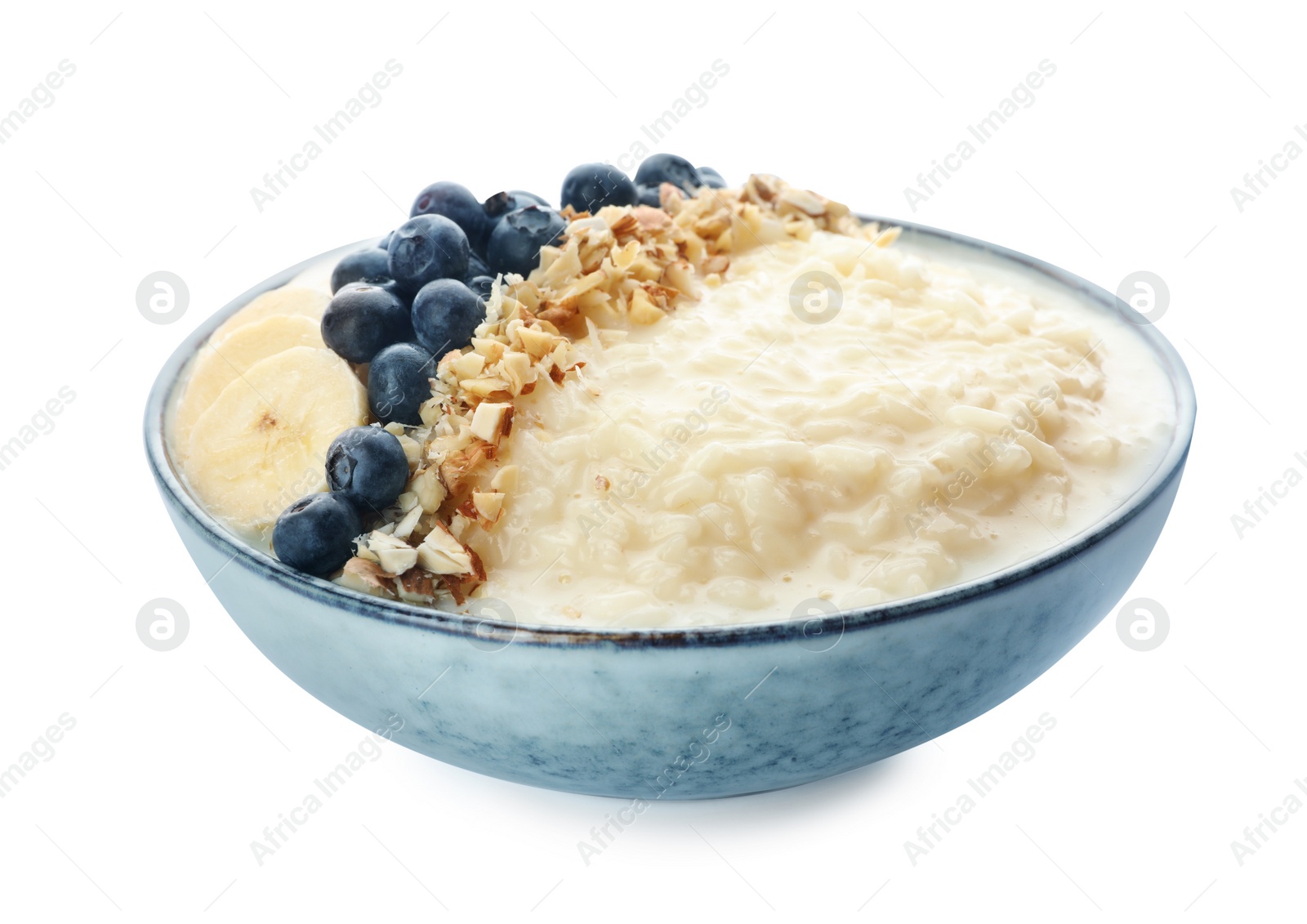 Photo of Delicious rice pudding with banana, blueberries and almond isolated on white