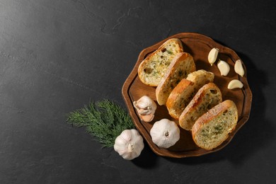 Tasty baguette with garlic and dill on grey table, top view. Space for text