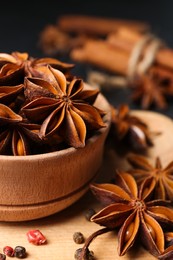 Photo of Aromatic anise stars and spices on tray, closeup