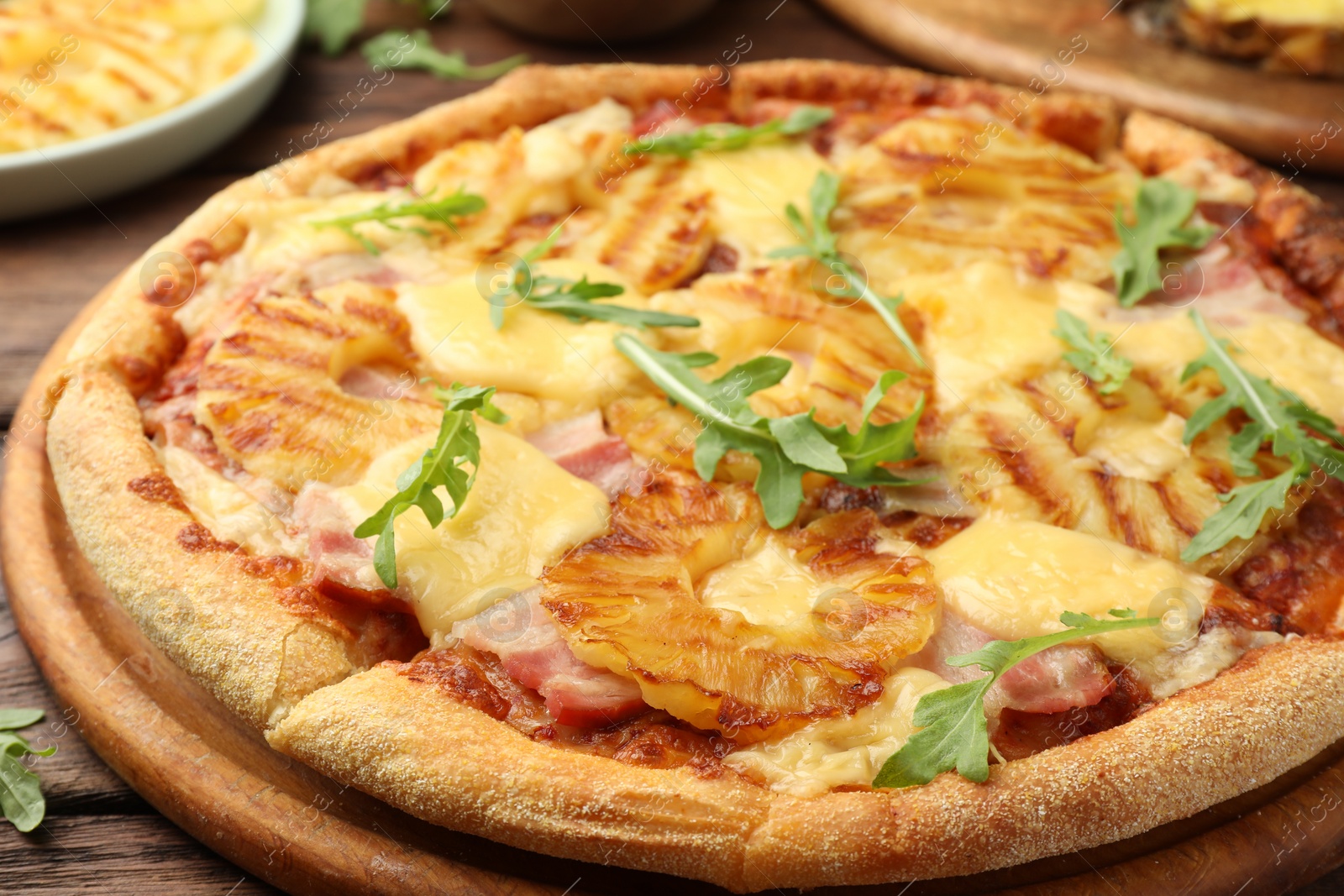 Photo of Delicious pineapple pizza with arugula on table, closeup