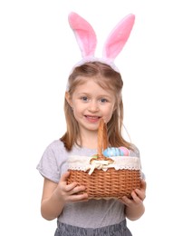 Easter celebration. Cute girl with bunny ears and wicker basket full of painted eggs isolated on white