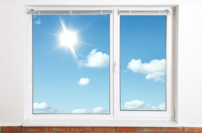 Beautiful view on blue sky with clouds through window