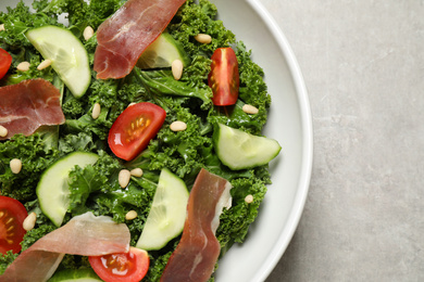 Photo of Delicious kale salad on grey table, top view