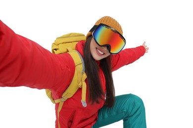 Photo of Smiling woman in ski goggles taking selfie on white background
